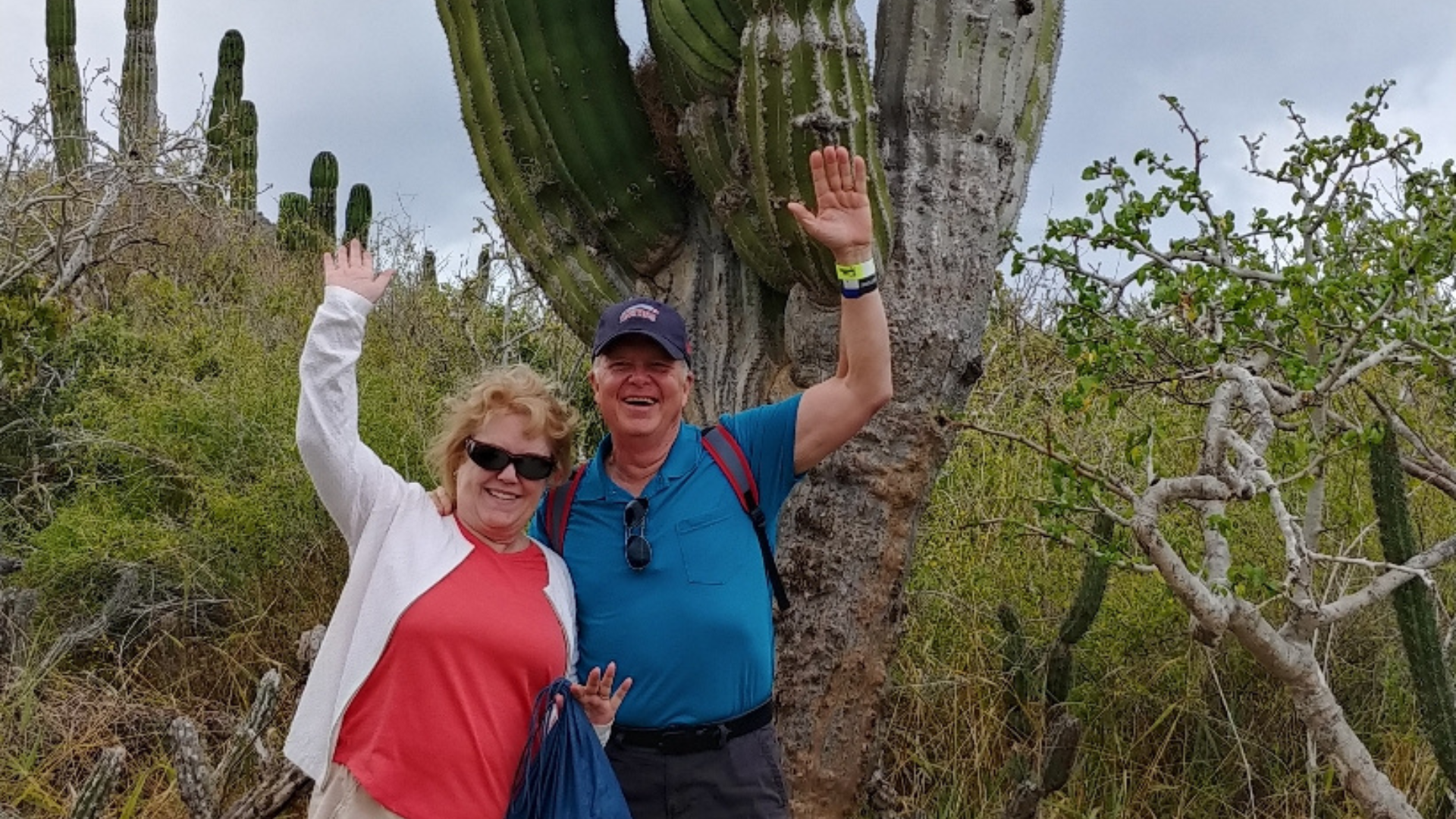 Barbara and her husband infront of a cactus